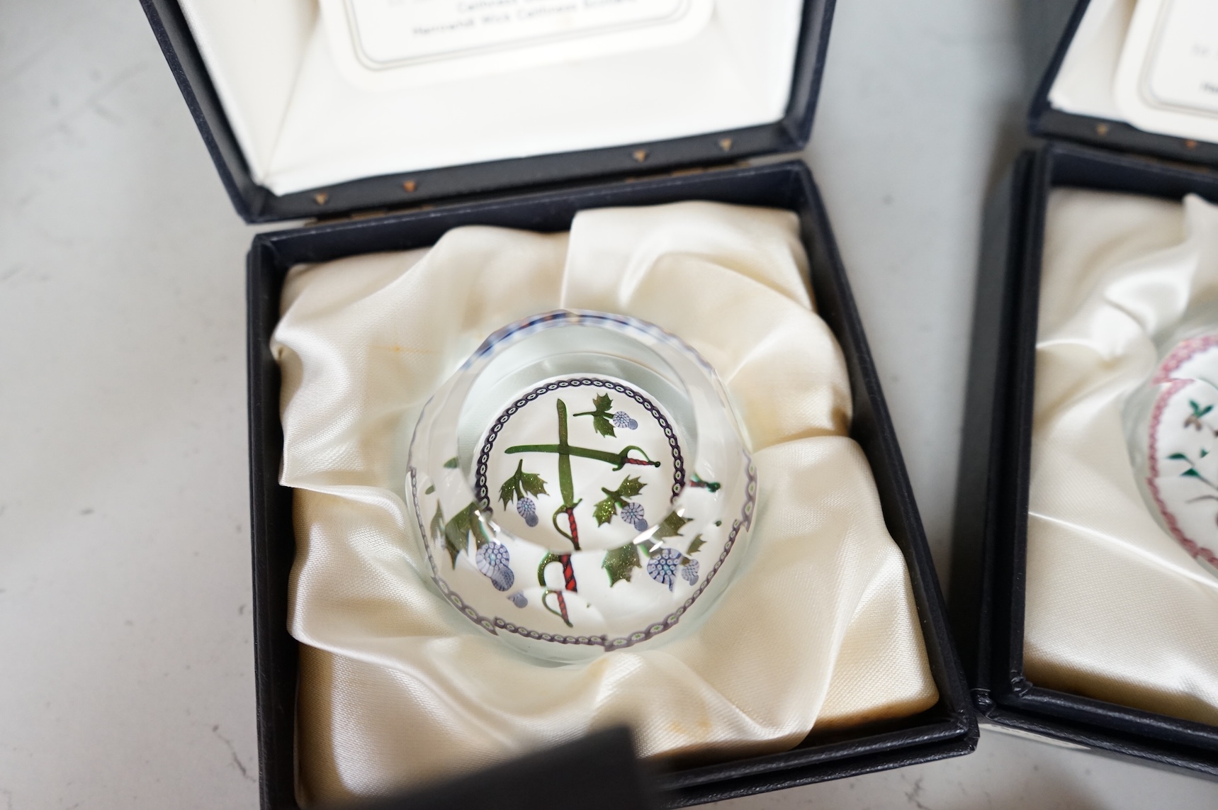 A group of five Caithness limited edition glass paperweights; highland fling, 01/250, Partridge in a pear tree, 56/500, Millefiori crown, 221/500, Rona, 56/500, Royal Birthday crown, 118/250 together with a moon crystal